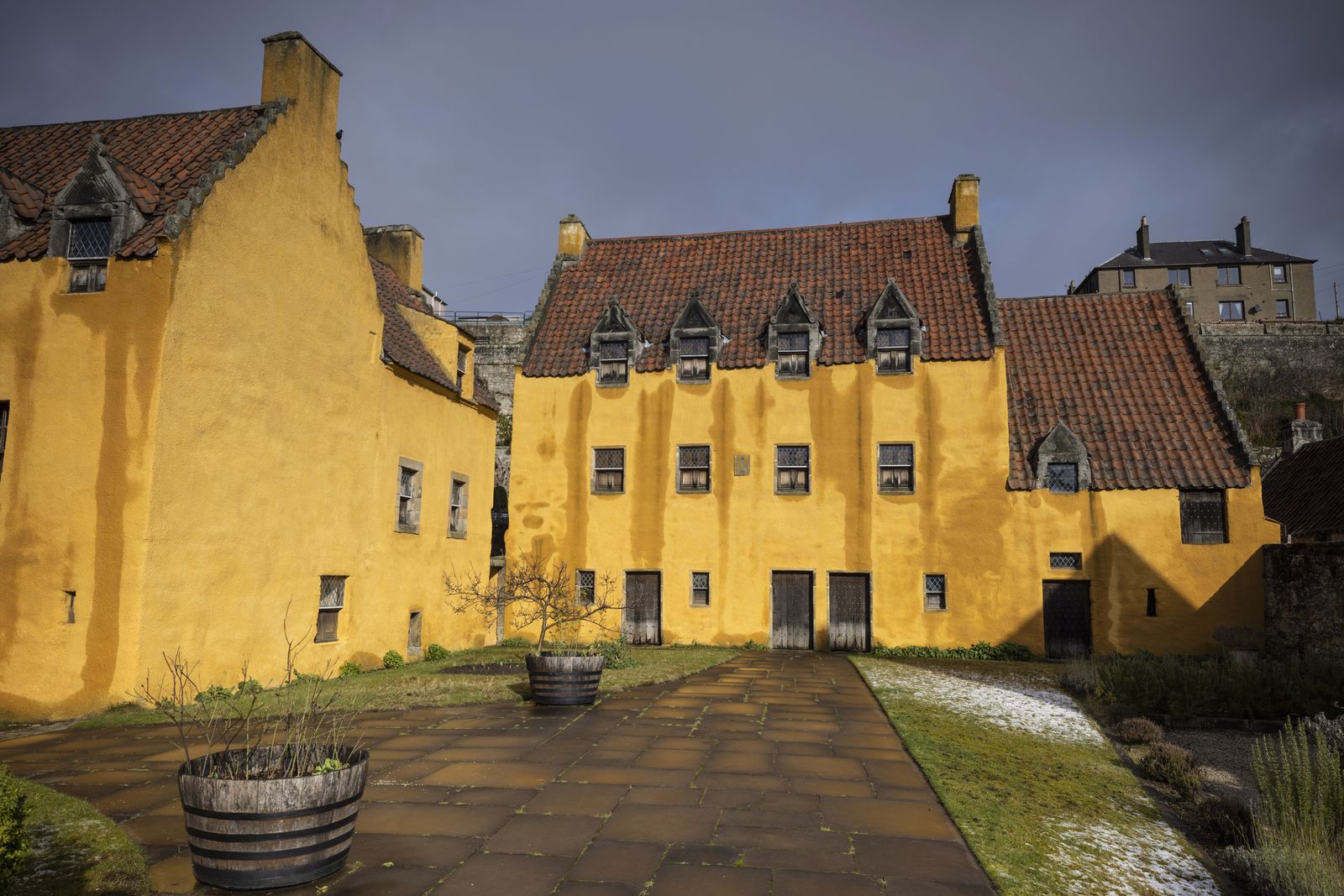 The ochre walls of Culross Palace and its courtyard